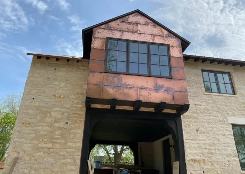 Copper metal panel facade on a stone building for Roof Repair in Knightdale